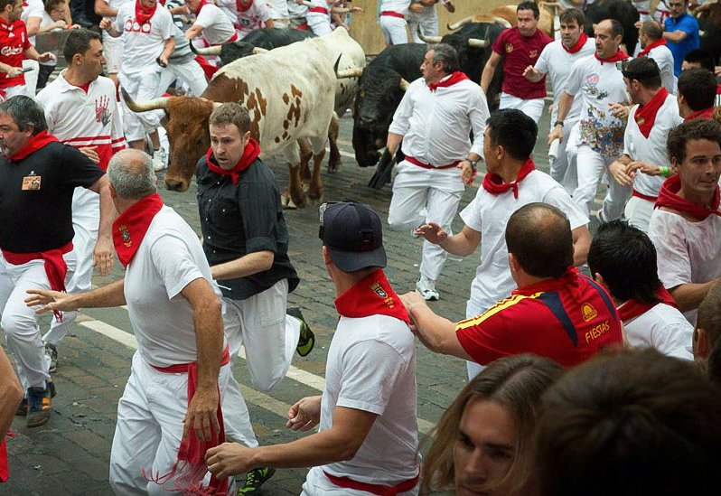 Dennis Clancey with the black shirt running with the bulls on Mercaderes Street 
