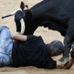 © REUTERS / Susana VeraReuters photographer Joseba Etxaburu is knocked down by a wild cow during festivities in the bullring following the sixth running of the bulls of the San Fermin festival in Pamplona July 12, 2012. Etxaburu suffered some scratches on his right elbow but was able to continue shooting afterwards.